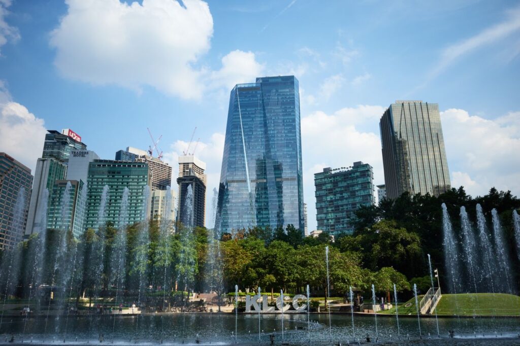 Capture of the iconic Kuala Lumpur skyline with fountains in the foreground.