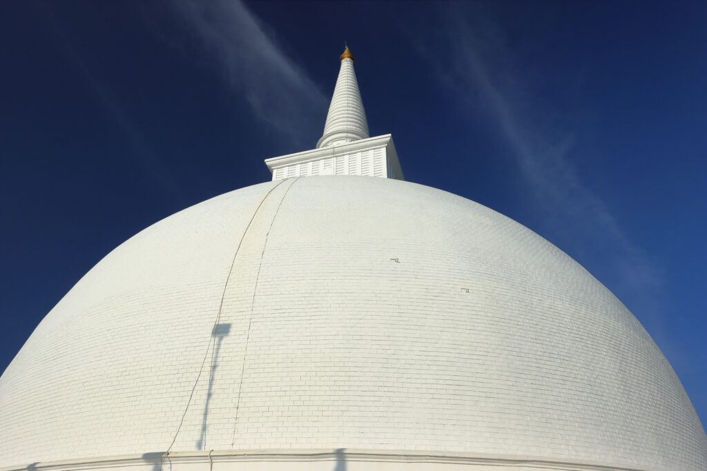 pexels-photo-34643549-34643549 Magnificent view of the Mihintale Stupa's white dome contrasting against a vivid blue sky in Sri Lanka.